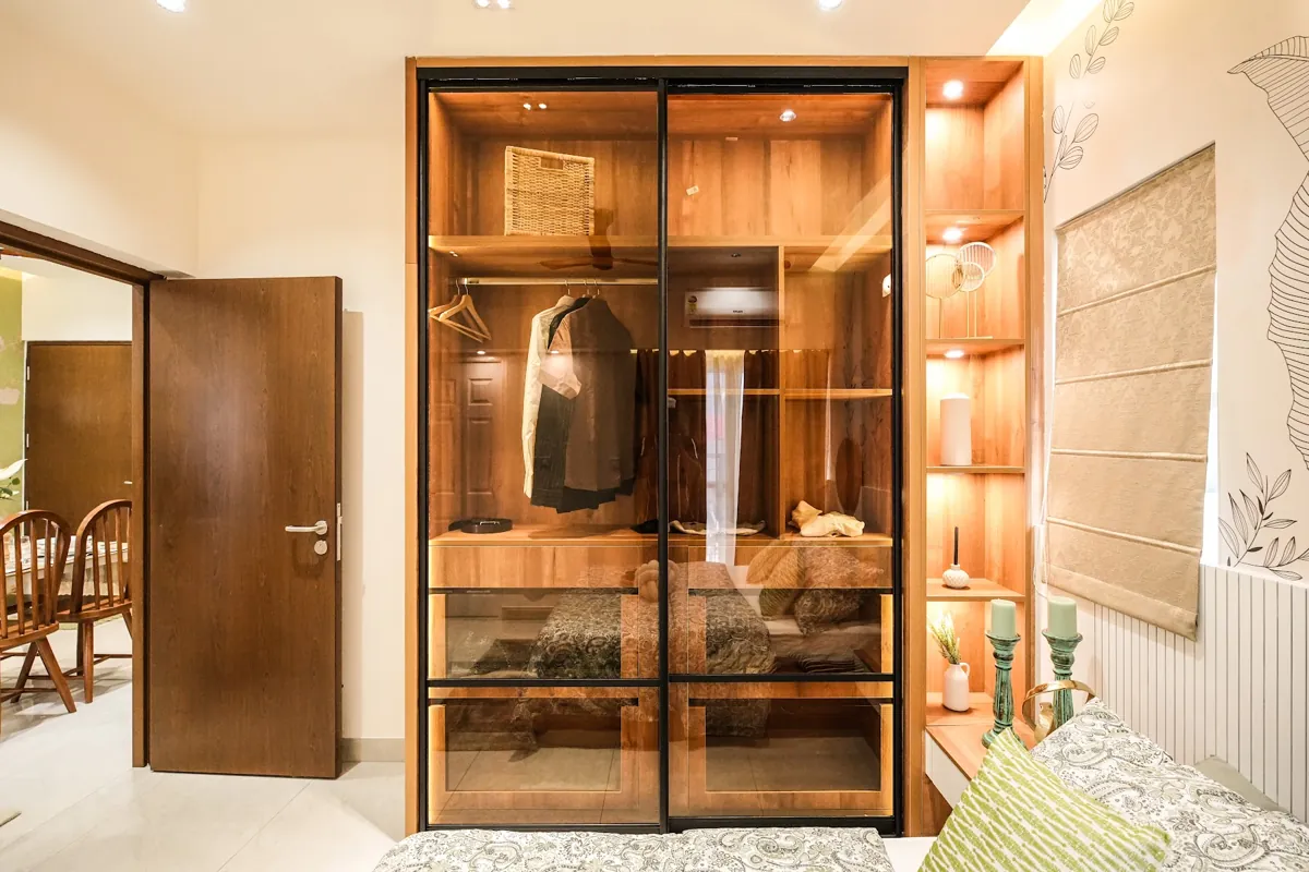 Glass and metal wardrobe with built-in lighting in a Nuvora bedroom