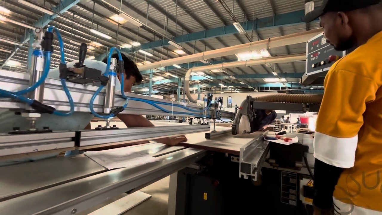 Nuvora artisan cutting panels on a panel saw in the factory